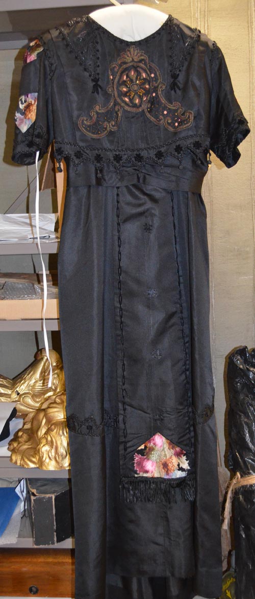 a%20black%2C%20short-sleeved%20satin%20dress%20with%20bead%20fringe%20and%20embroidery